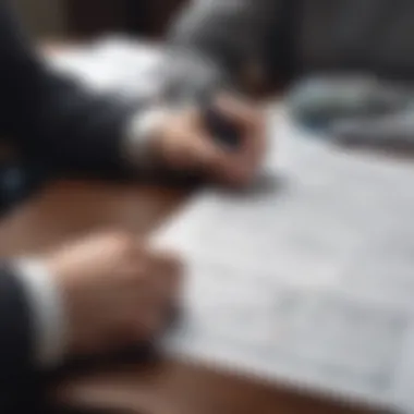 A person reviewing financial documents at a table